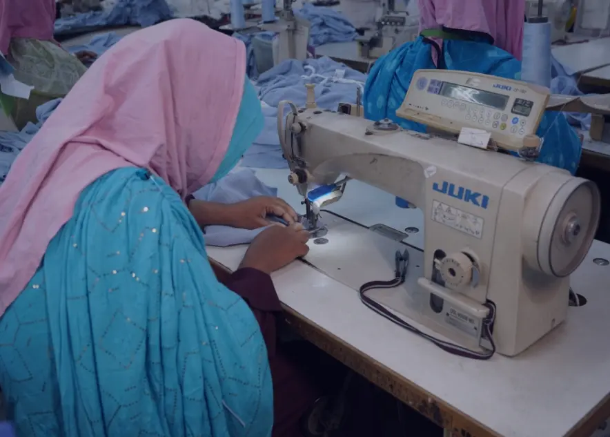 A seamstress sewing clothing at an ID® partner factory